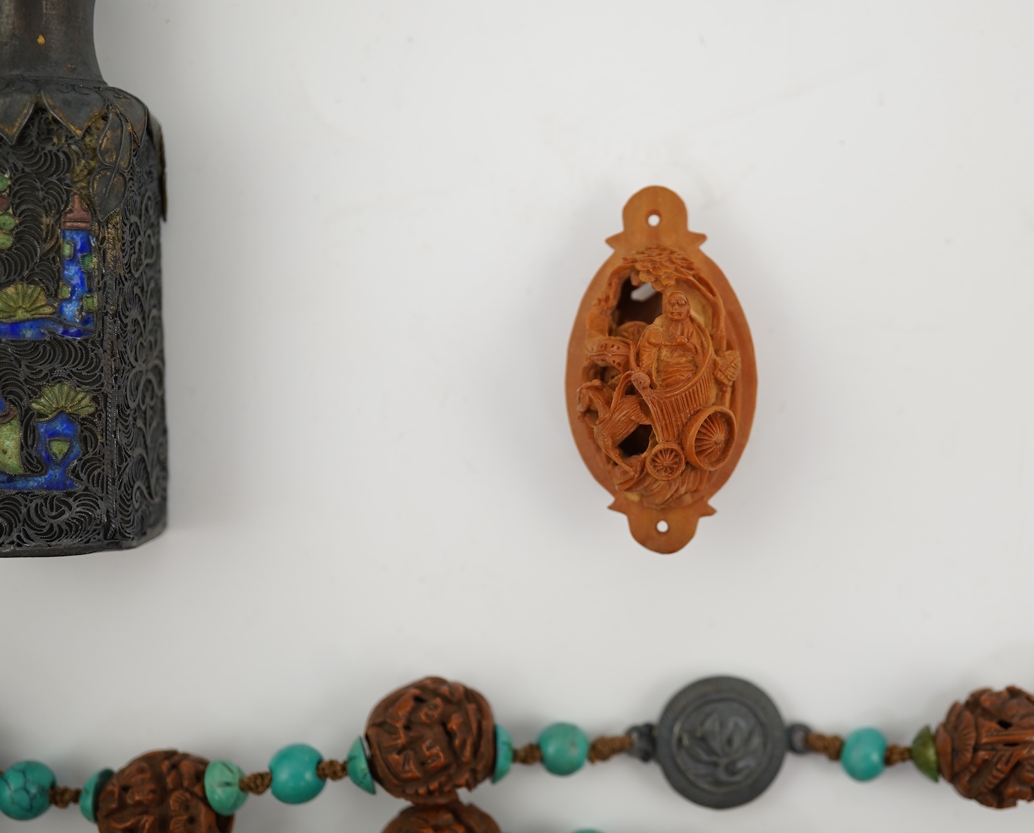 A Chinese silver filigree work and enamel scent bottle, by Wongshing, three carved peach stones, and a kernel and turquoise bead necklace, late 19/early 20th century